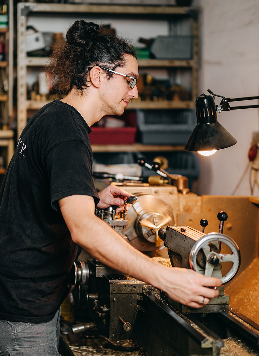 A coppersmith turning at the lathe