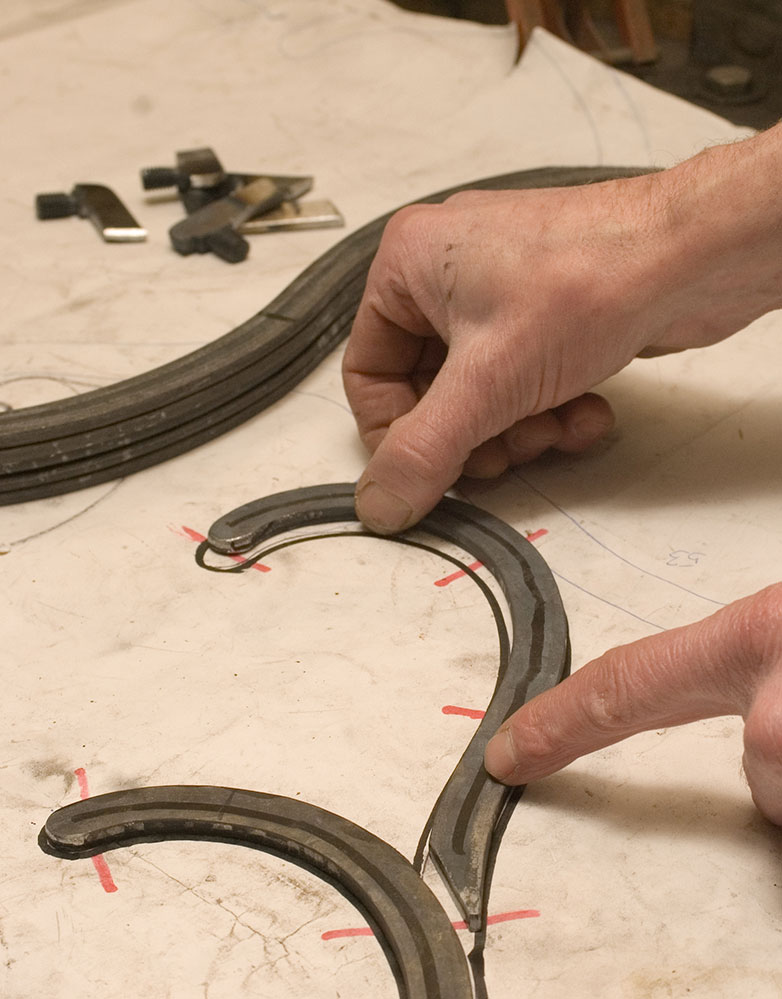 Checking bent frame parts against the drawing